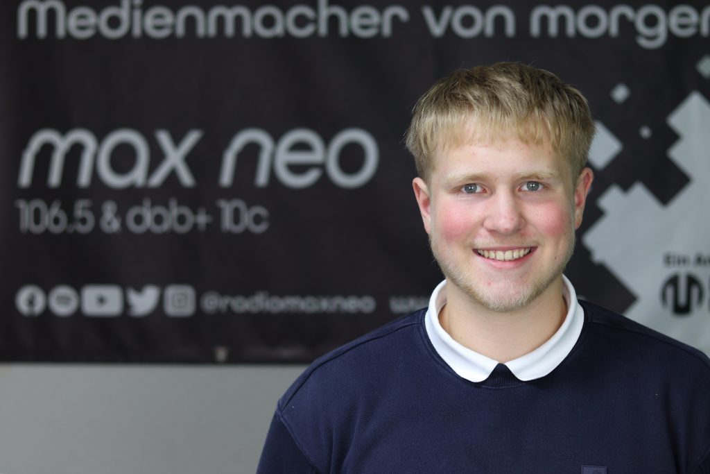 Das Foto zeigt Noah Knirsch im Porträt vor dem max neo Banner.